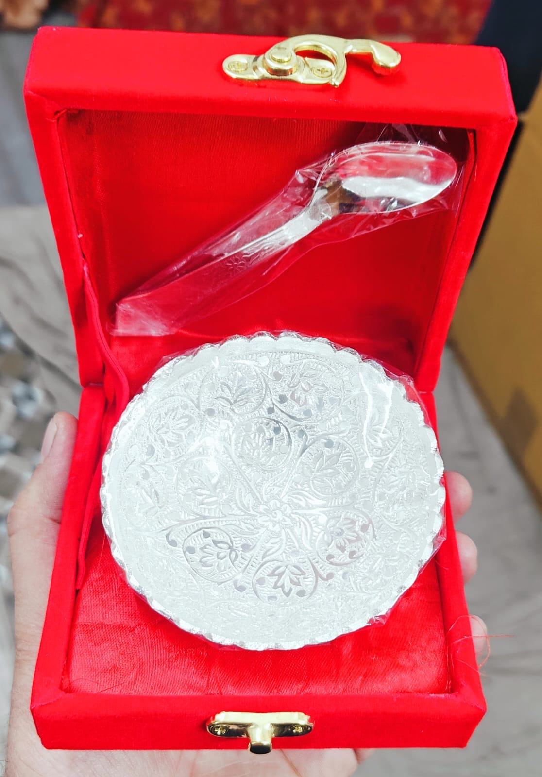 Silver decorative bowl in a red velvet box with a gold emblem for traditional return gifts