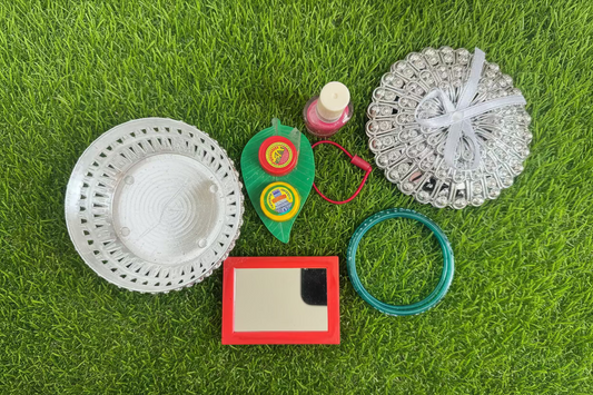 Shop Sumangali pooja and Varalakshmi pooja set  including a silver metal bowl, a small red-framed mirror, glass bangles, a pink nail polish bottle, and a hair band and Haldi kumkum leaf set at Murugan Decors USA