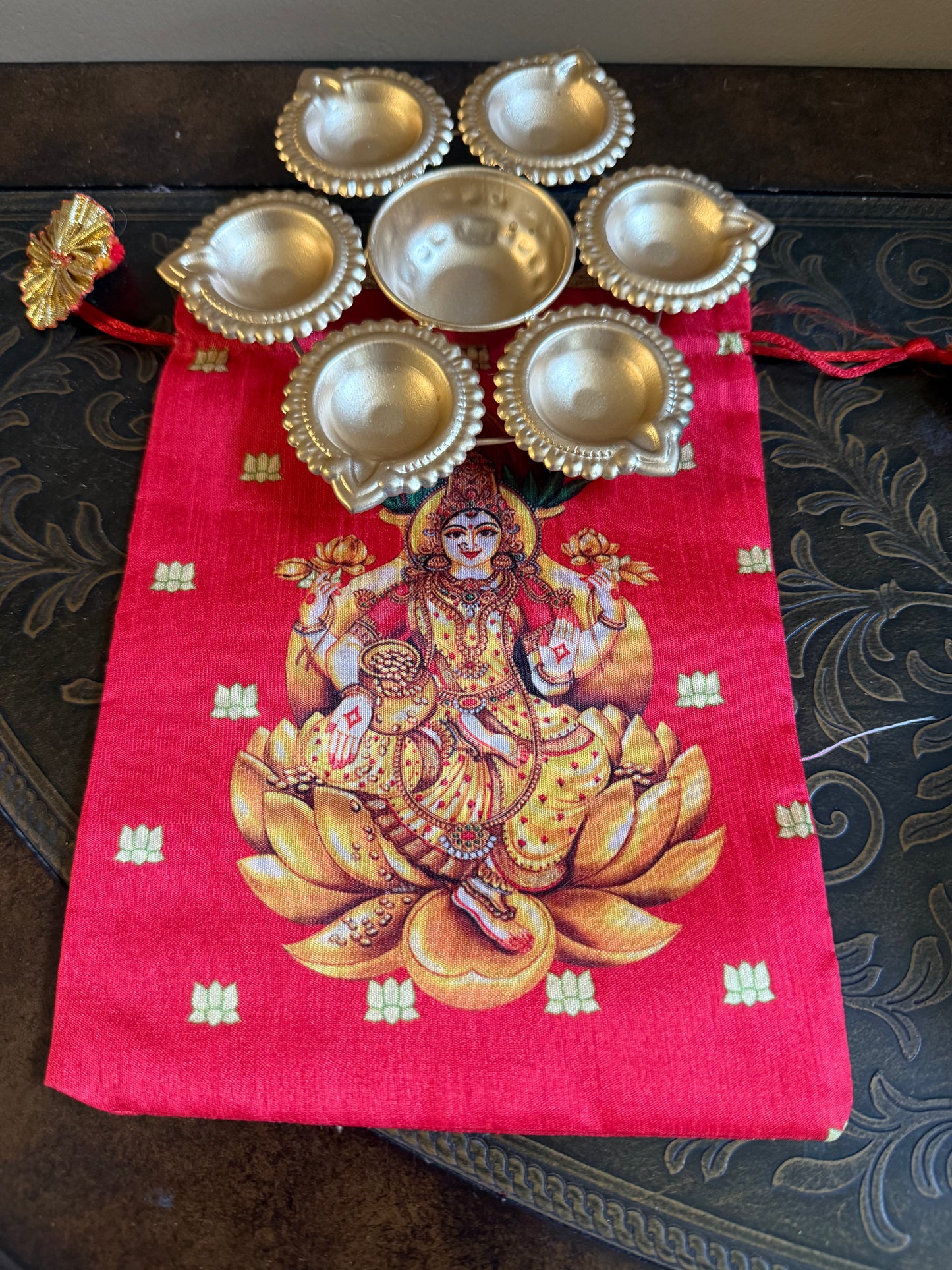 Shop  metal Urli Diya with Lakshmi printed  Potli bag for traditional return gifts in USA at Murugandecors 