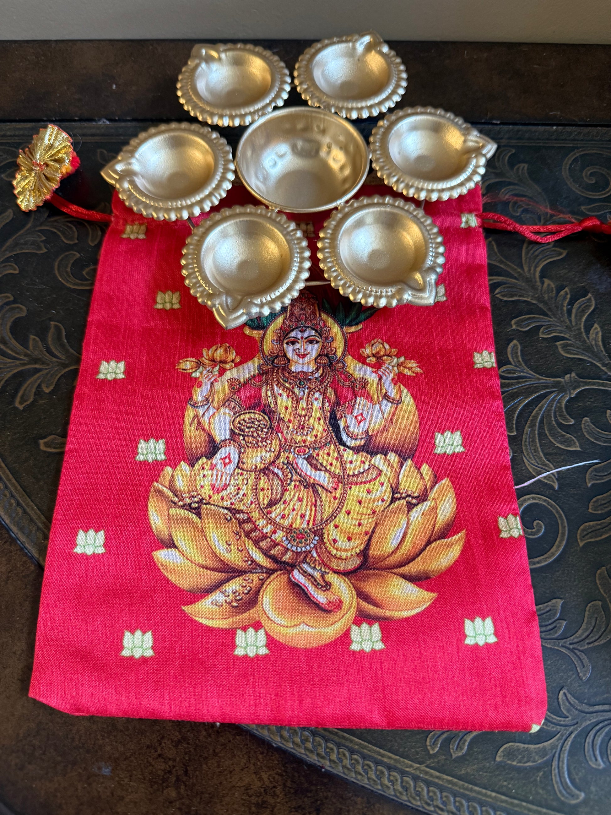 Shop  metal Urli Diya with Lakshmi printed  Potli bag for traditional return gifts in USA at Murugandecors 
